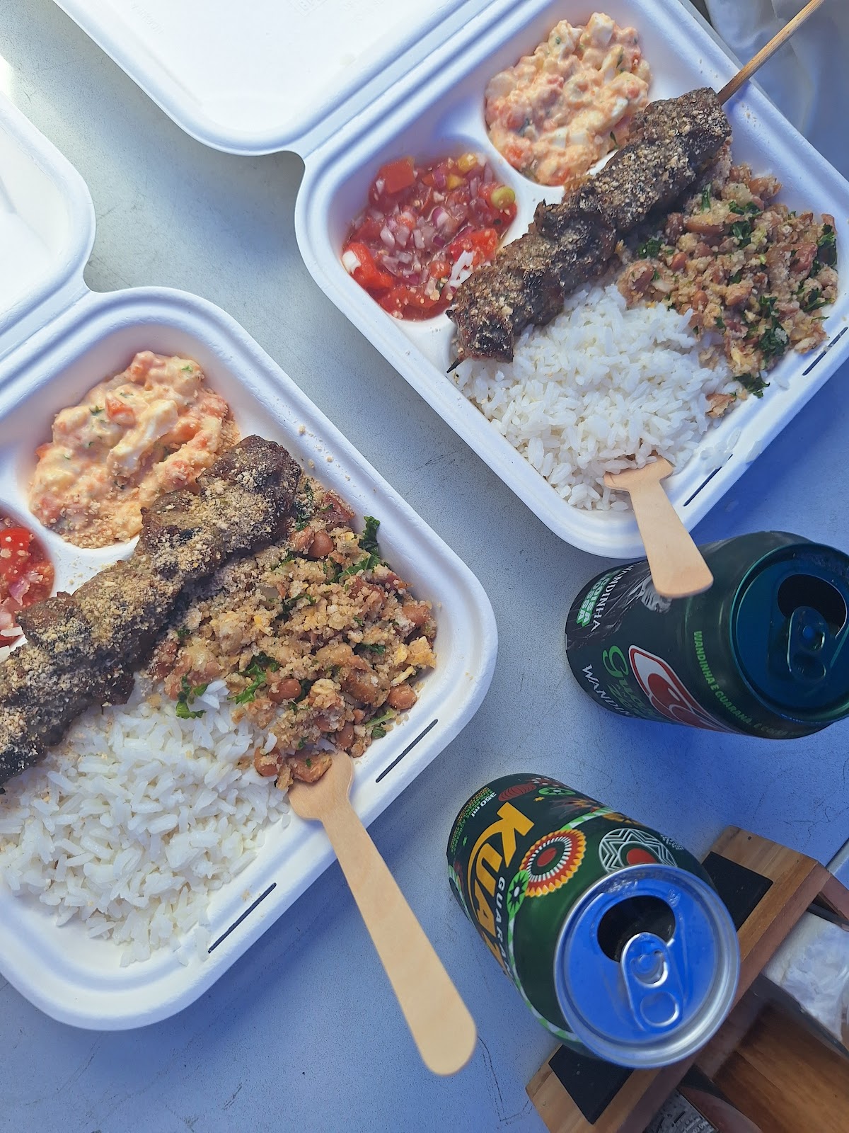 Two boxes of skewers and sides on the table